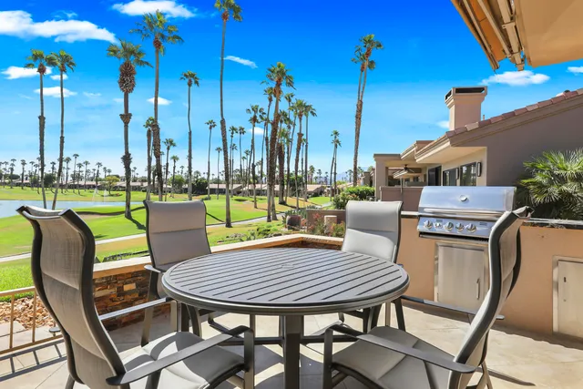 a view of a chairs with a table in the patio
