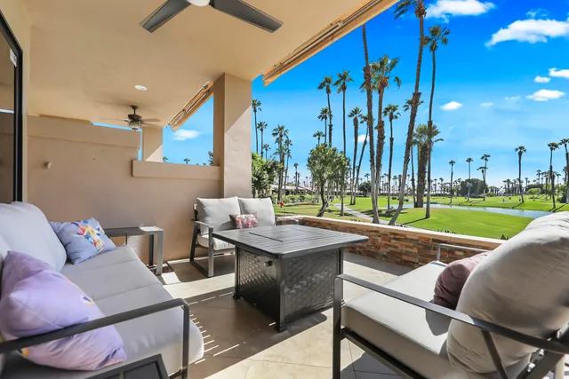 a view of a patio with a table and chairs