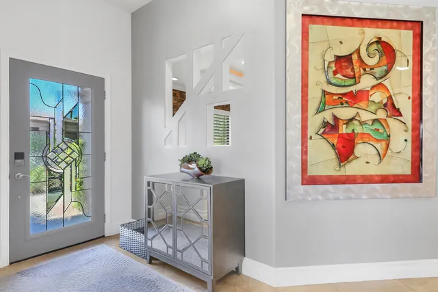 a living room with furniture and a painting on the wall