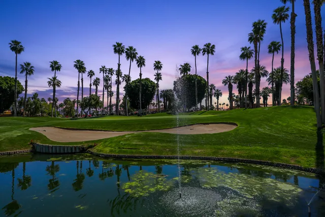 a view of a park with a house in the background