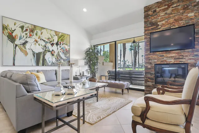 a living room with fireplace furniture and a flat screen tv