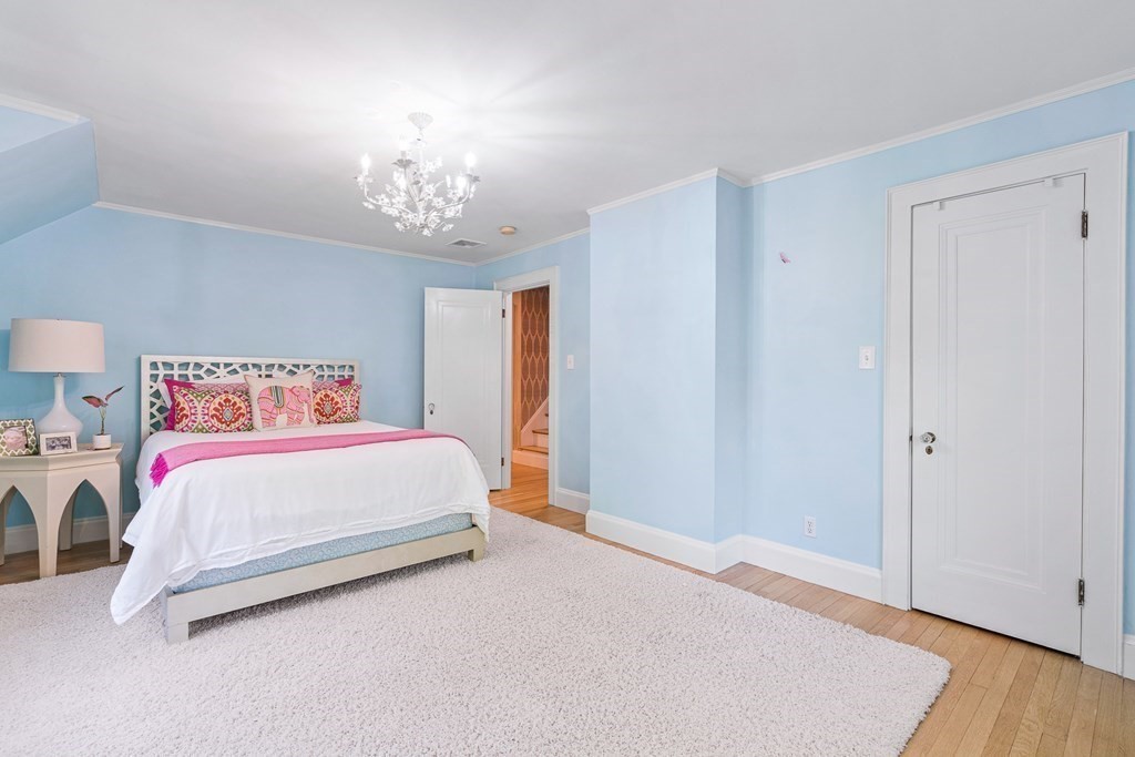 25 Emerson Road Wellesley, MA 02481 - Photo 30 of 42 a bedroom with a bed and a chandelier