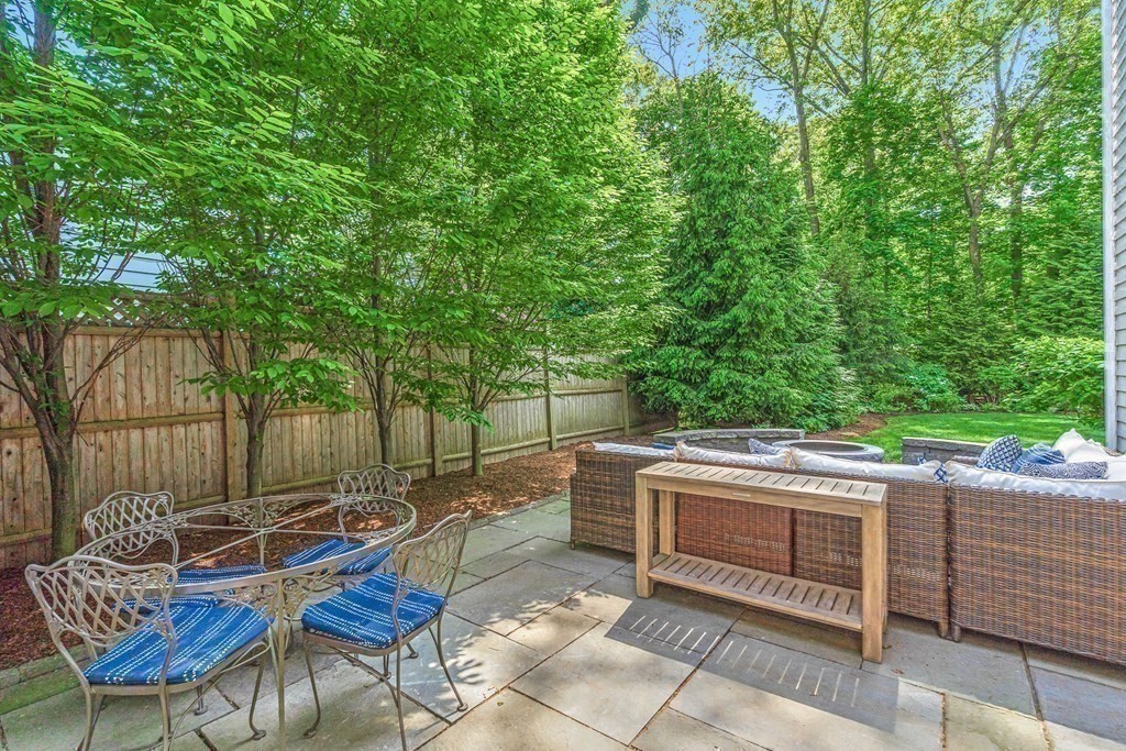25 Emerson Road Wellesley, MA 02481 - Photo 39 of 42 a view of a chairs and tables in the back yard of the house
