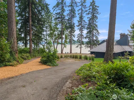 a view of a house with a yard swimming pool and outdoor seating