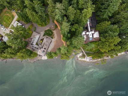 an aerial view of a house with a yard
