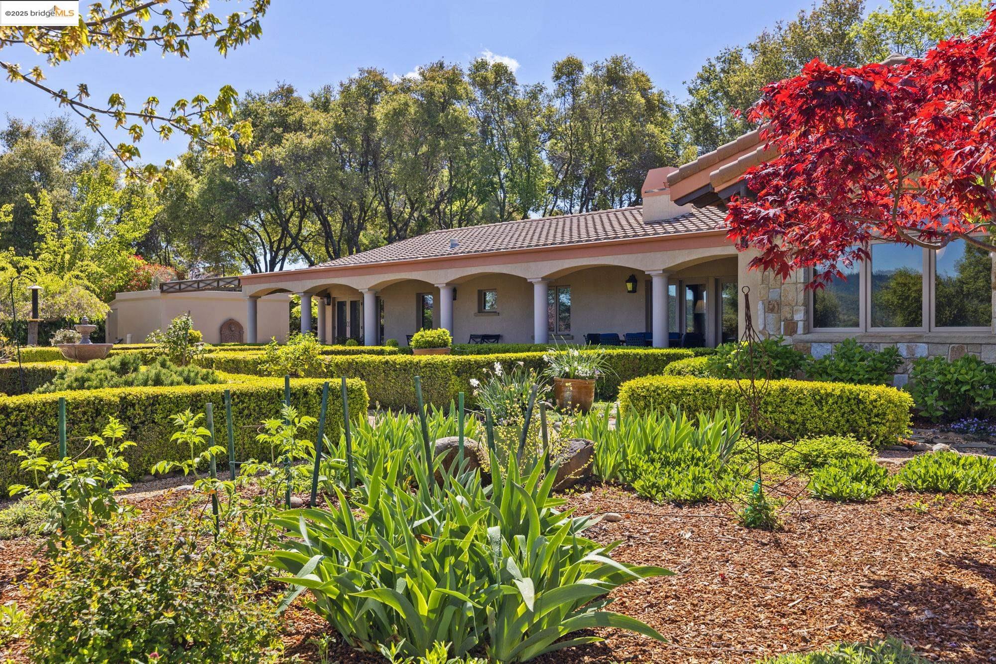 10270 Slate Rim Road Sonora, CA 95370 - Photo 44 of 55 a front view of a house with a garden and swimming pool