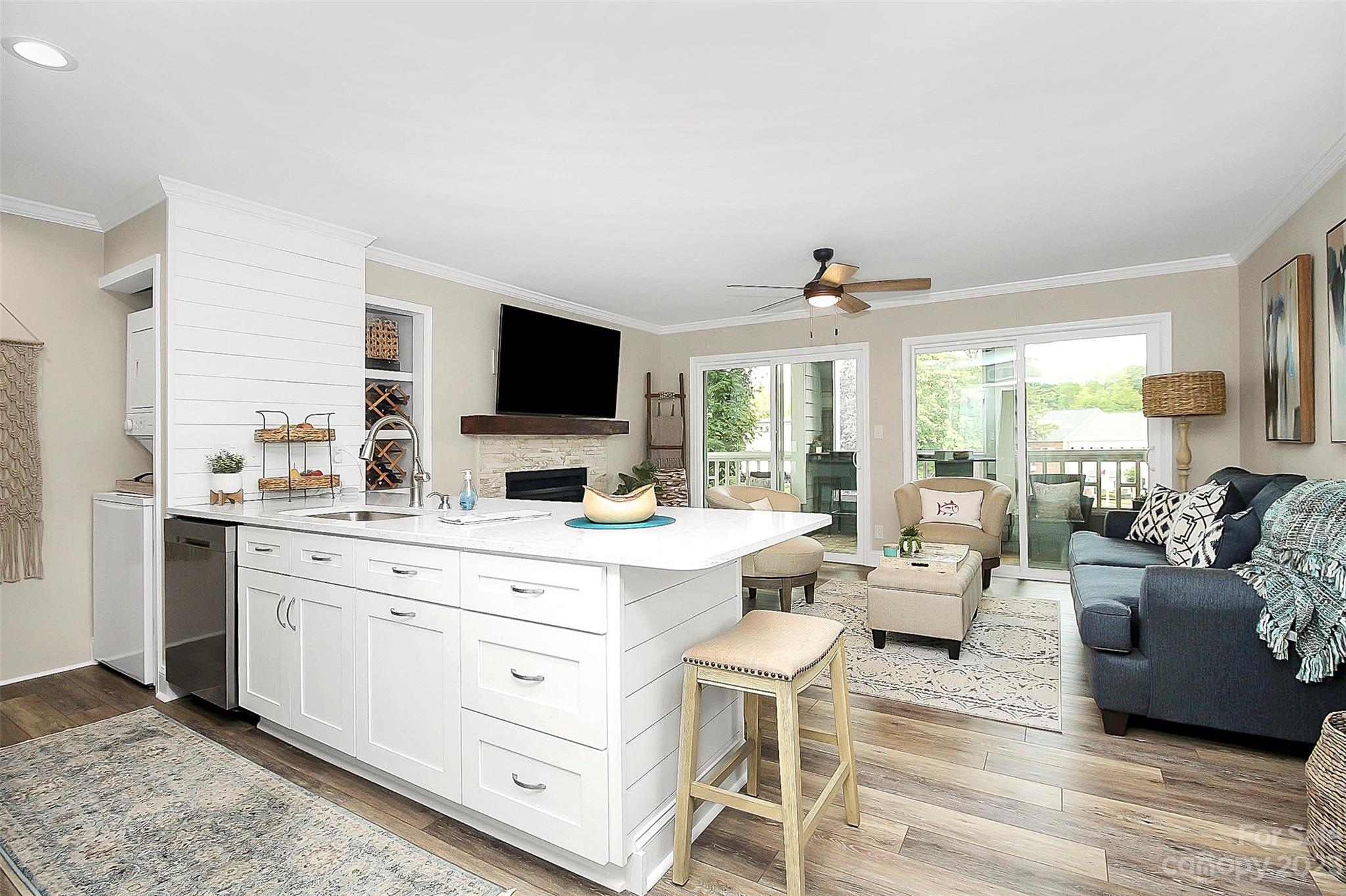 205 Northwest Drive, Unit 38 Davidson, NC 28036 - Photo 12 of 32 a living room with furniture flat screen tv and large window