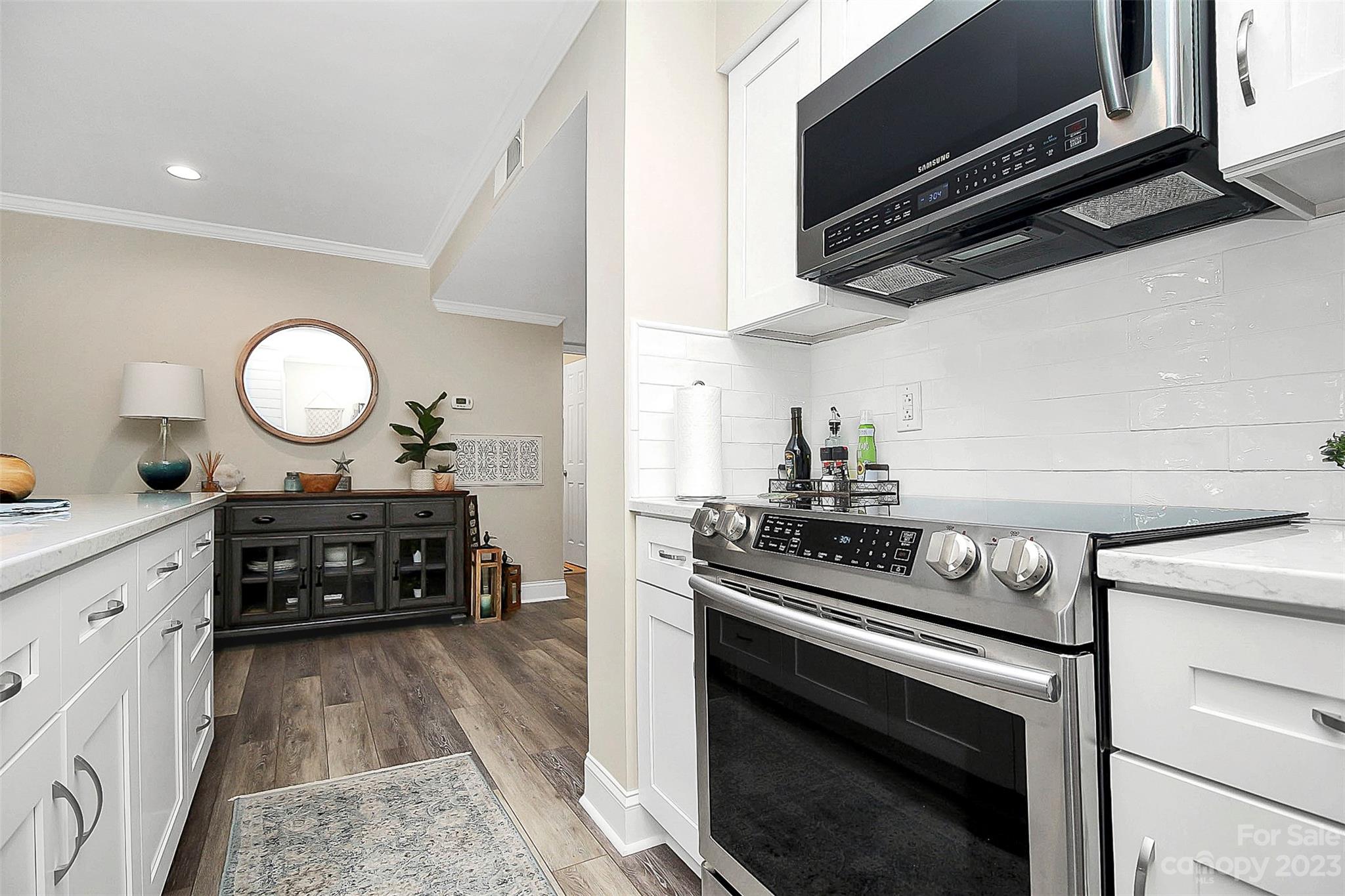 205 Northwest Drive, Unit 38 Davidson, NC 28036 - Photo 18 of 32 a kitchen with a stove and a microwave
