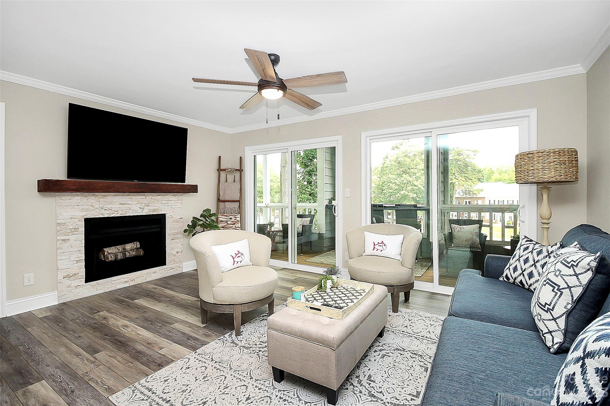 205 Northwest Drive, Unit 38 Davidson, NC 28036 - Photo 19 of 32 a living room with furniture a flat screen tv and a fireplace