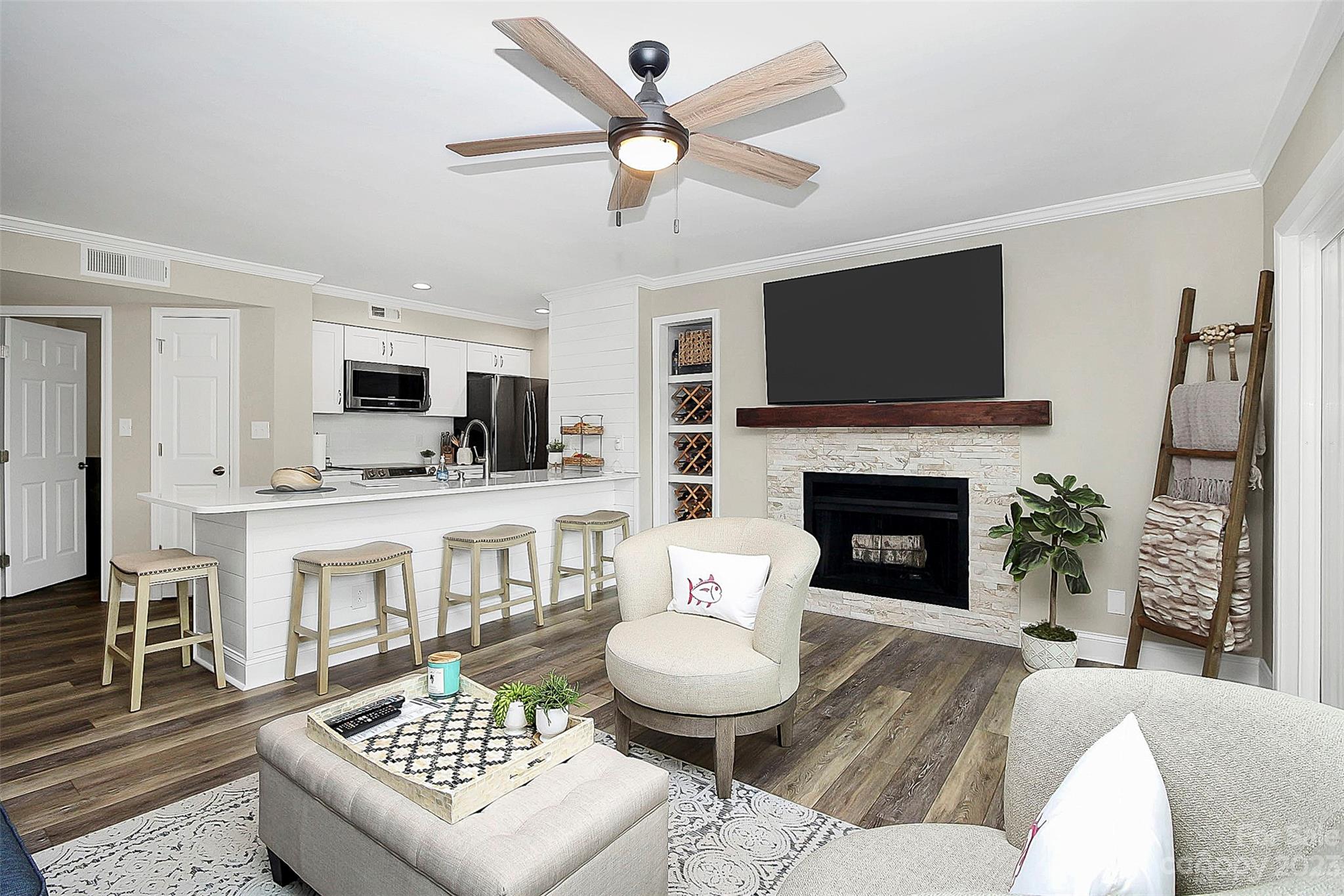 205 Northwest Drive, Unit 38 Davidson, NC 28036 - Photo 20 of 32 a living room with furniture a fireplace and a flat screen tv