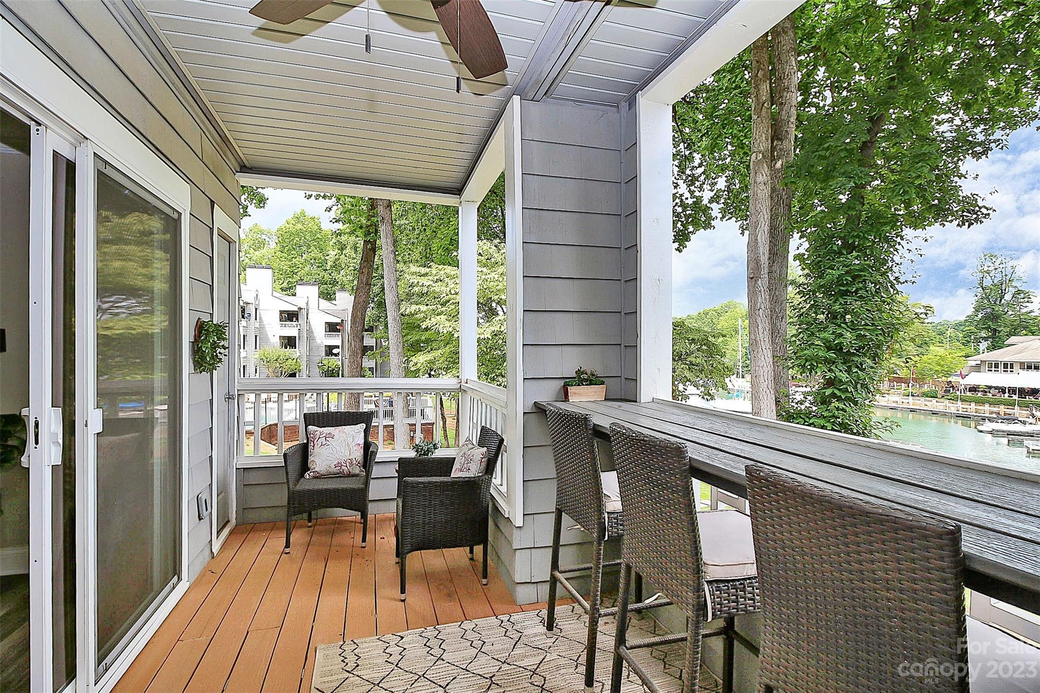 205 Northwest Drive, Unit 38 Davidson, NC 28036 - Photo 24 of 32 a balcony with chairs and outdoor view