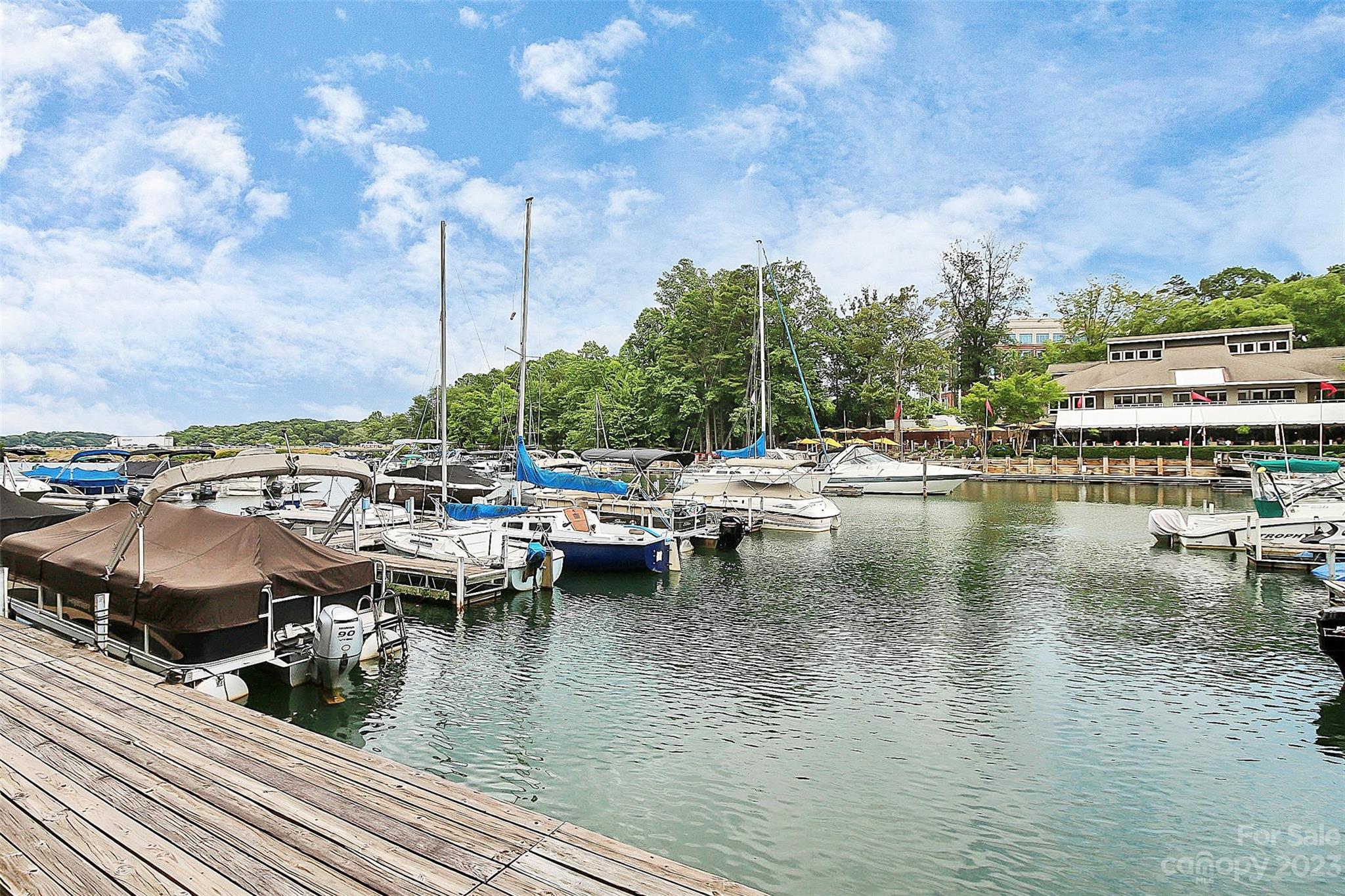 205 Northwest Drive, Unit 38 Davidson, NC 28036 - Photo 29 of 32 a view of a lake with lawn chairs
