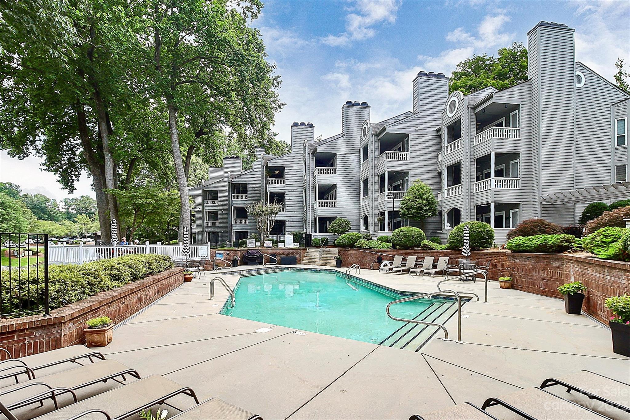 205 Northwest Drive, Unit 38 Davidson, NC 28036 - Photo 30 of 32 a building view with swimming pool and outdoor seating