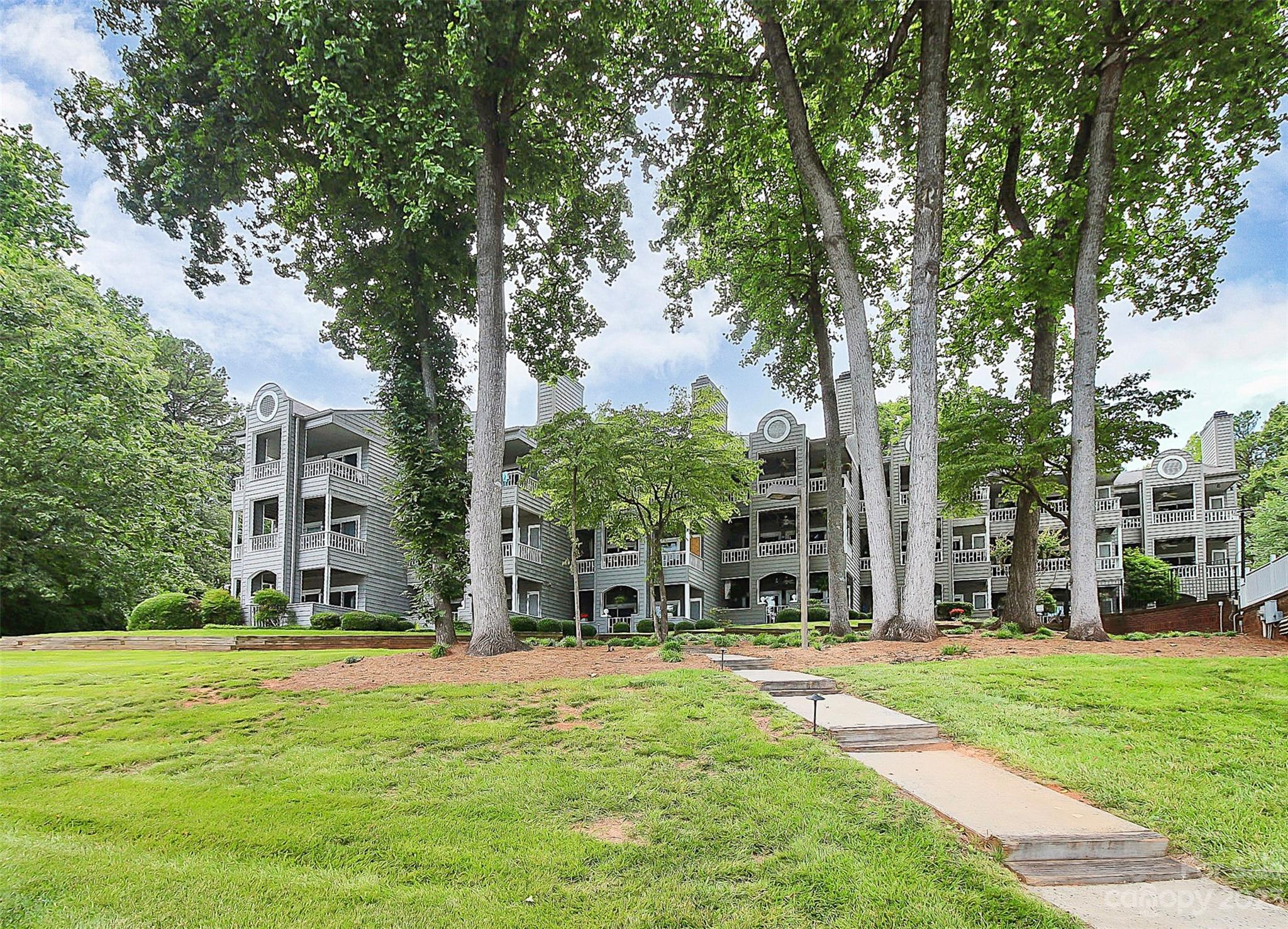 205 Northwest Drive, Unit 38 Davidson, NC 28036 - Photo 32 of 32 a view of a building with a yard