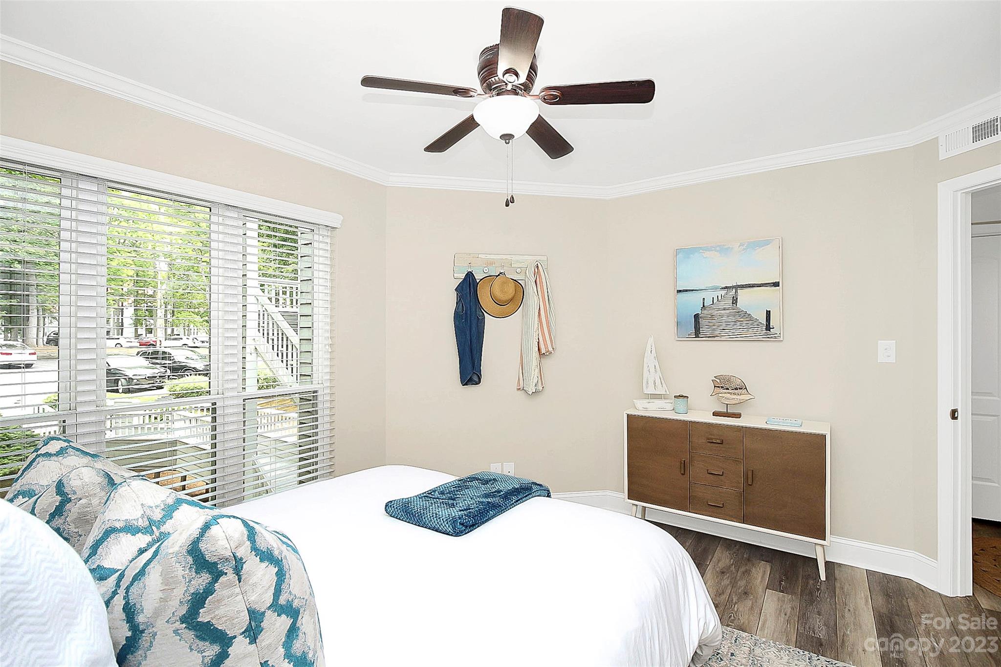 205 Northwest Drive, Unit 38 Davidson, NC 28036 - Photo 6 of 32 a bedroom with a bed and wooden floor