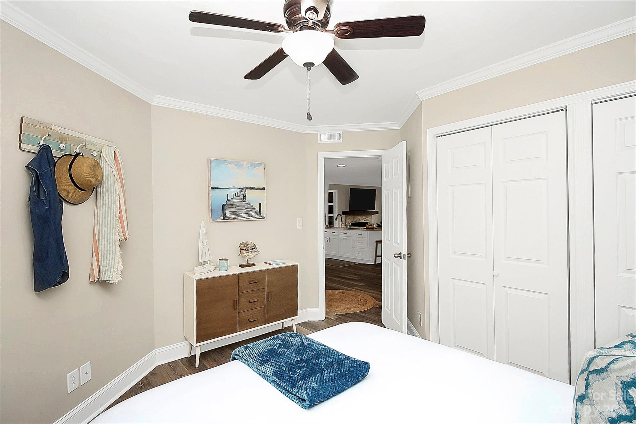 205 Northwest Drive, Unit 38 Davidson, NC 28036 - Photo 7 of 32 a bedroom with a bed and a chandelier