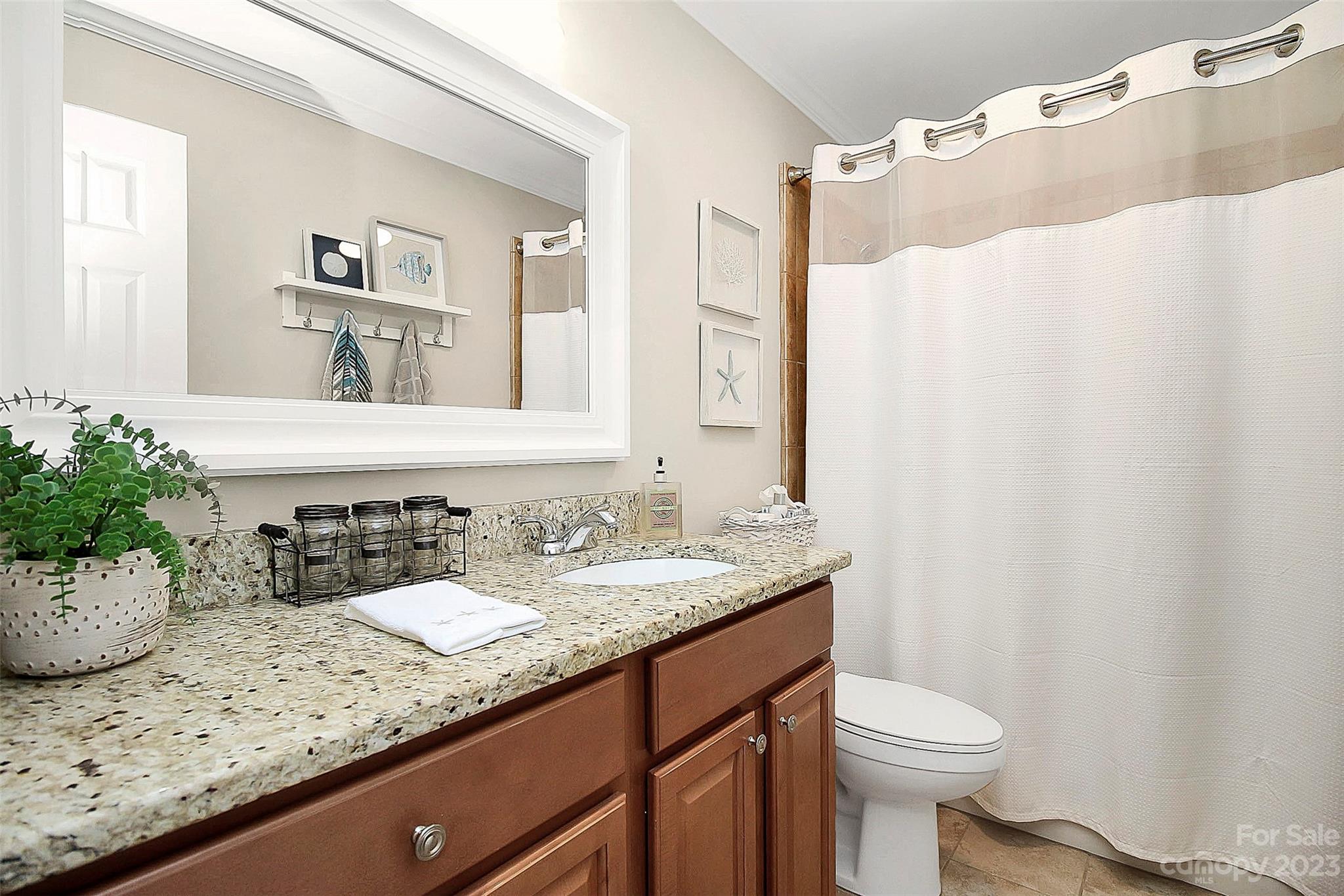 205 Northwest Drive, Unit 38 Davidson, NC 28036 - Photo 8 of 32 a bathroom with a granite countertop sink and a mirror
