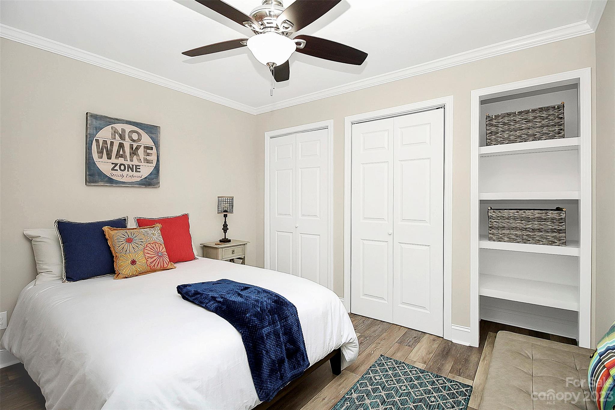 205 Northwest Drive, Unit 38 Davidson, NC 28036 - Photo 9 of 32 a bedroom with a bed and a walk in closet