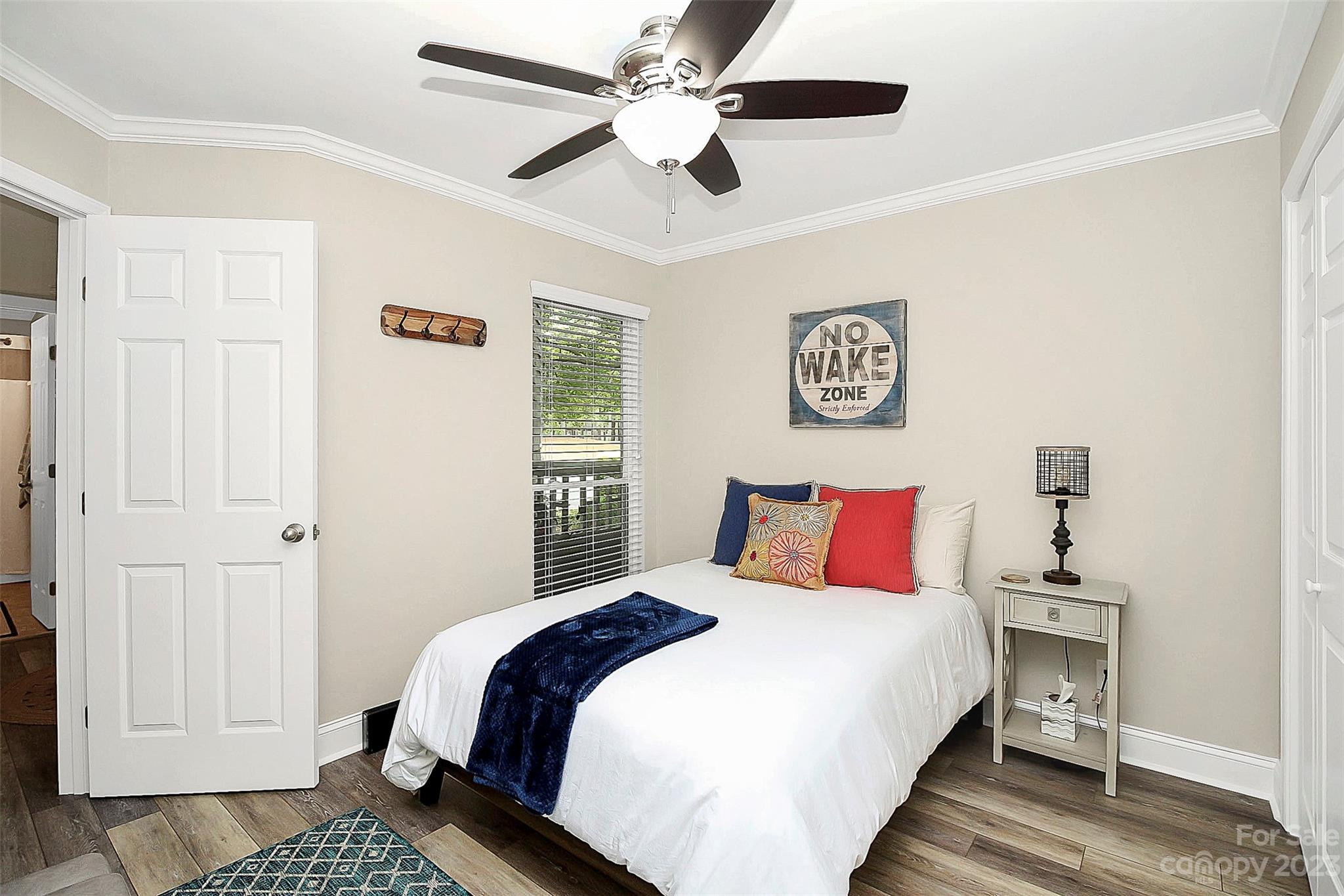 205 Northwest Drive, Unit 38 Davidson, NC 28036 - Photo 10 of 32 a bedroom with a large bed and a chandelier