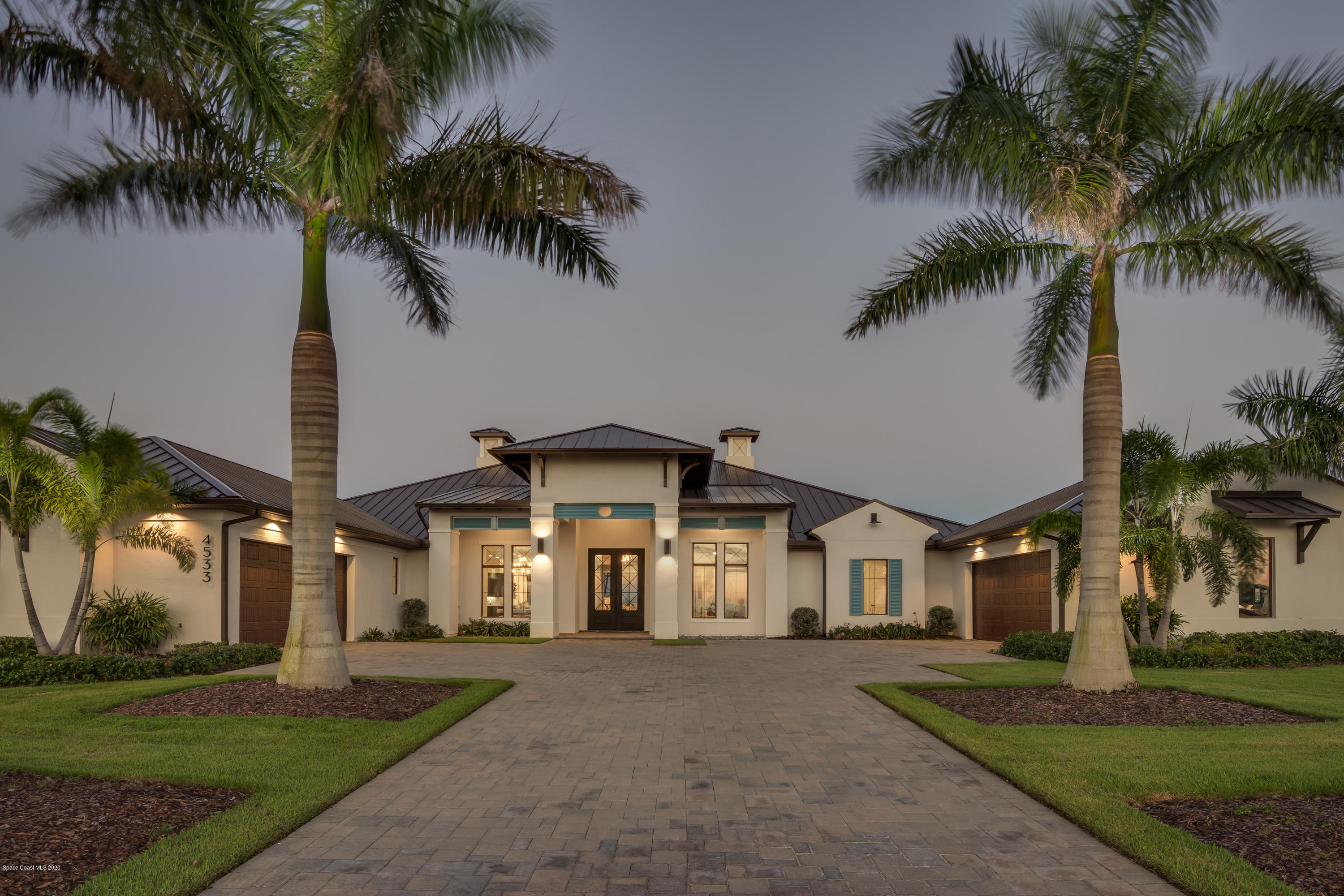a front view of house with a garden