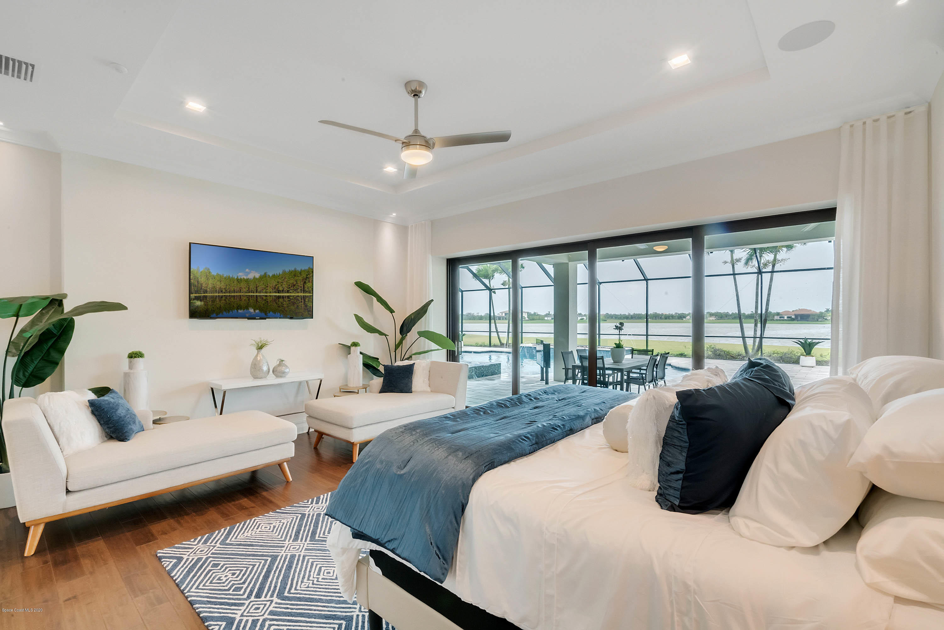 4533 Milost Drive Rockledge, FL 32955 - Photo 13 of 49 a bedroom with a bed a couch and a flat tv screen on dresser