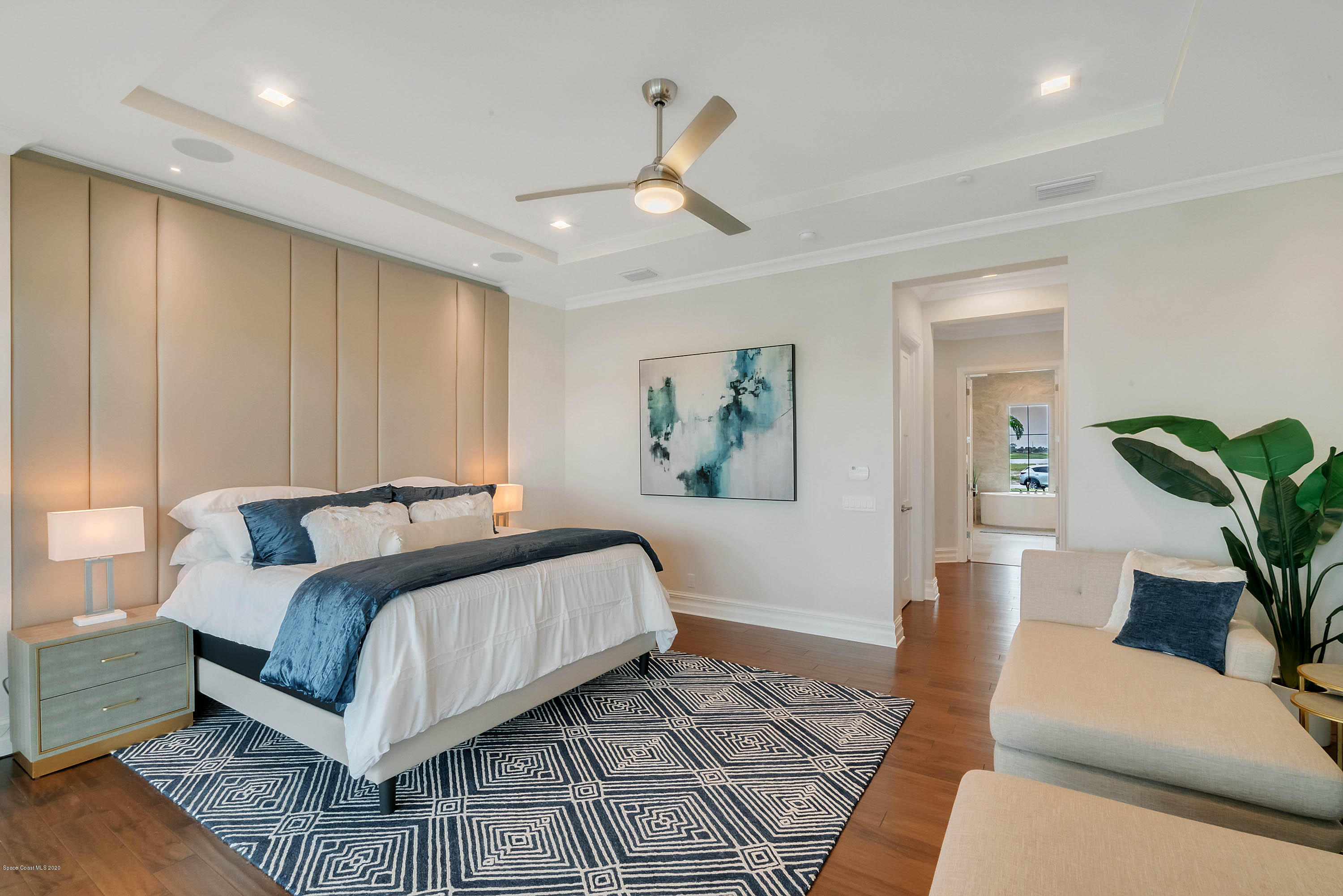 4533 Milost Drive Rockledge, FL 32955 - Photo 15 of 49 a bedroom with a large bed and a chandelier