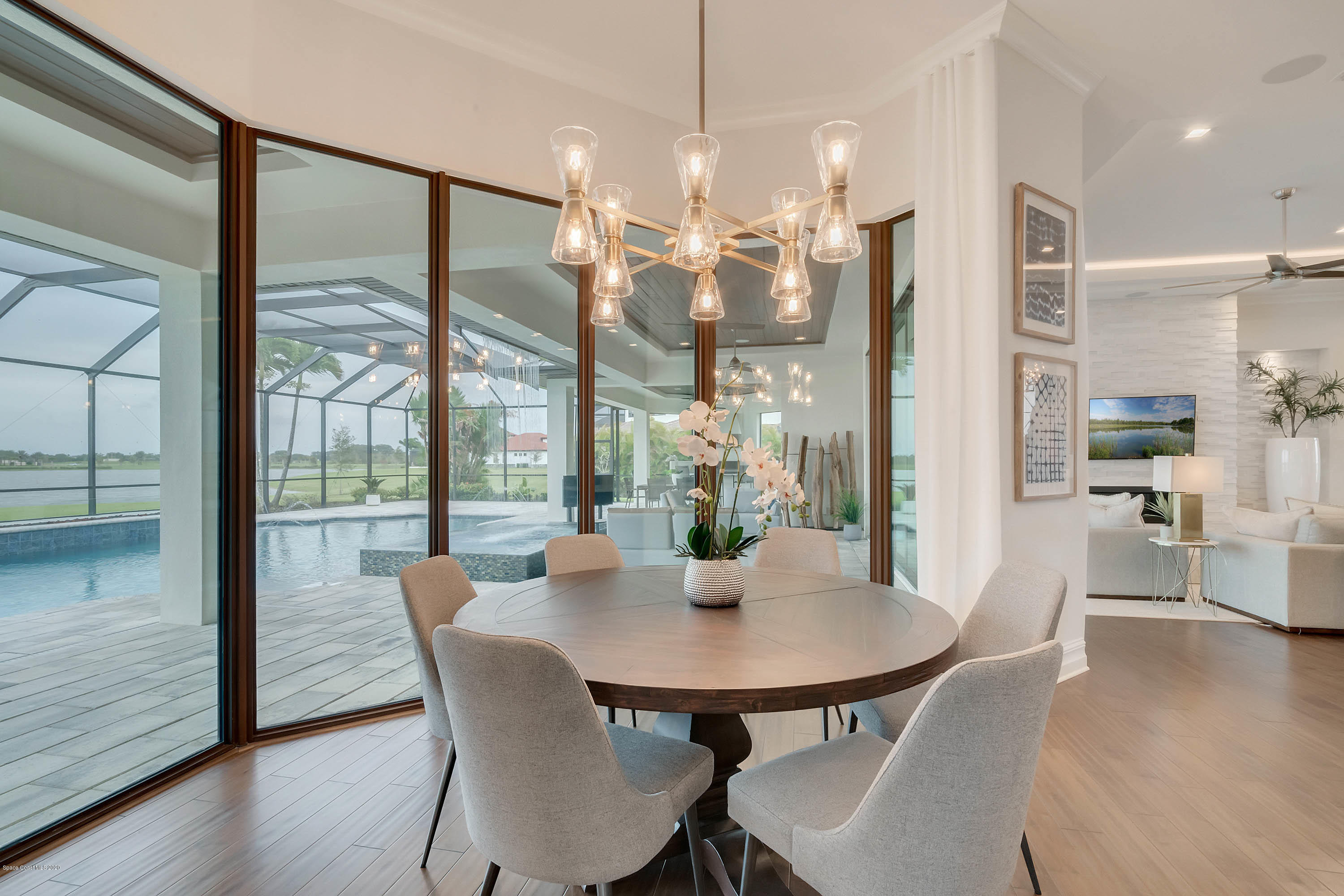 4533 Milost Drive Rockledge, FL 32955 - Photo 33 of 49 a dining room with furniture a chandelier and wooden floor