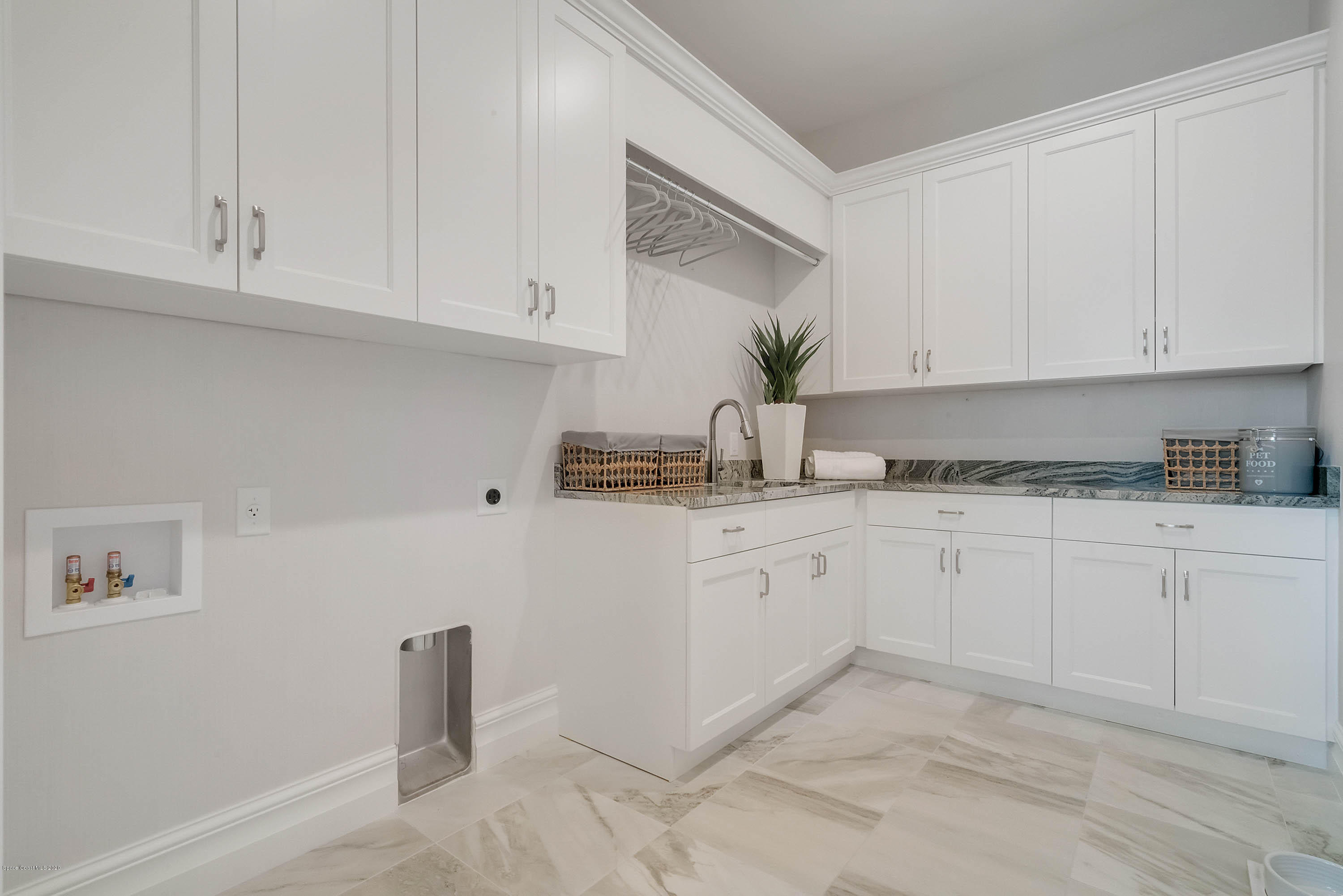4533 Milost Drive Rockledge, FL 32955 - Photo 37 of 49 a kitchen with granite countertop white cabinets and white appliances