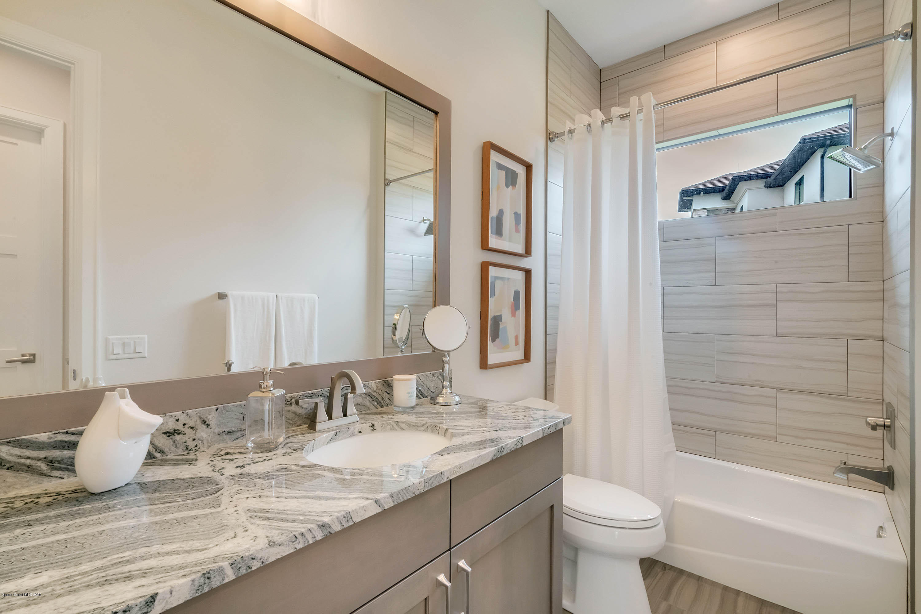 4533 Milost Drive Rockledge, FL 32955 - Photo 40 of 49 a bathroom with a granite countertop sink toilet and shower