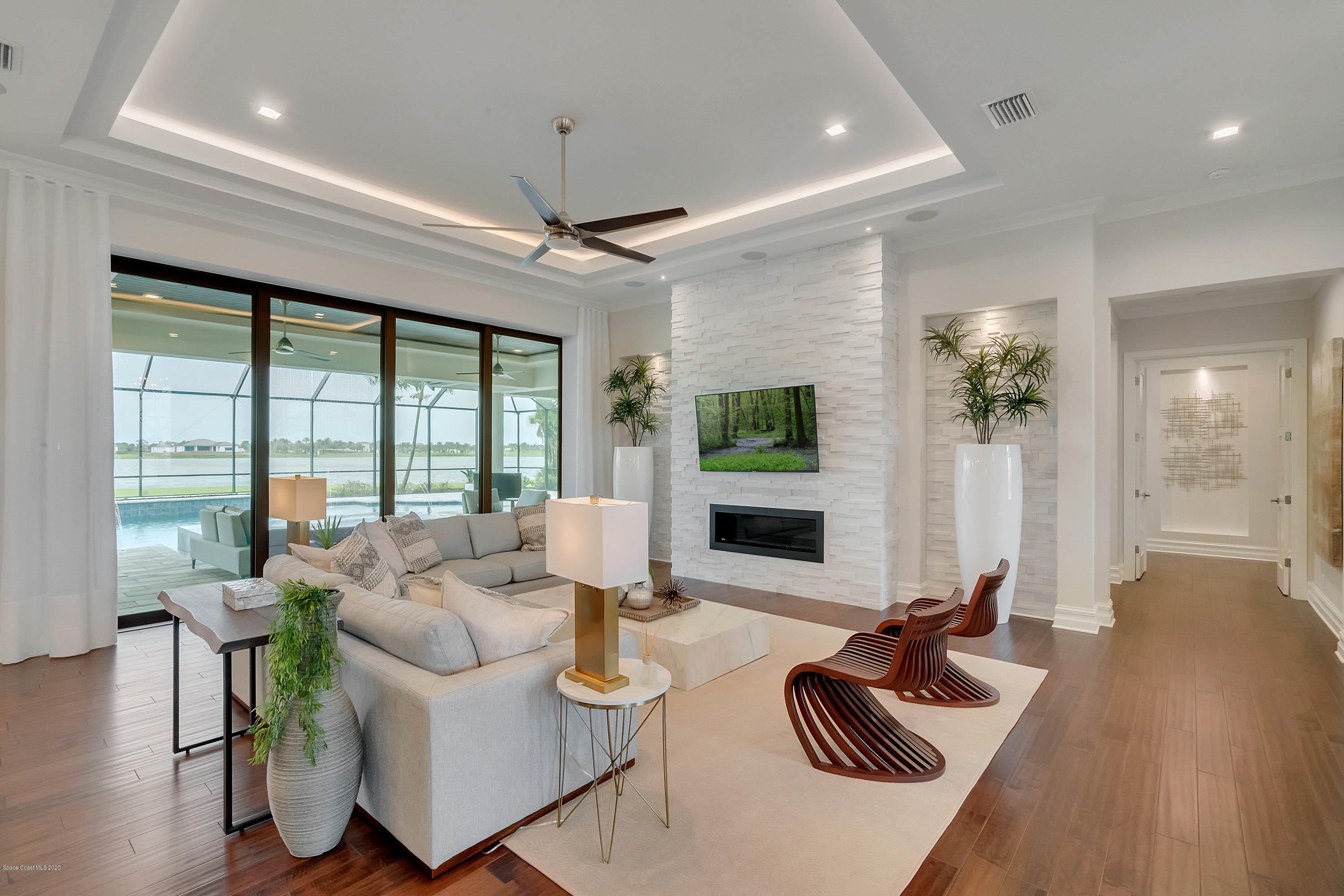 4533 Milost Drive Rockledge, FL 32955 - Photo 8 of 49 a living room with furniture floor to ceiling window and wooden floor
