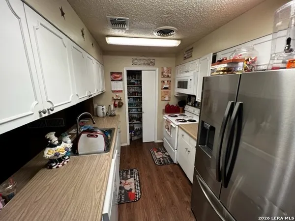 a kitchen with stainless steel appliances a refrigerator and a stove