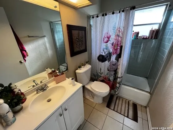 a bathroom with a sink mirror vanity and toilet