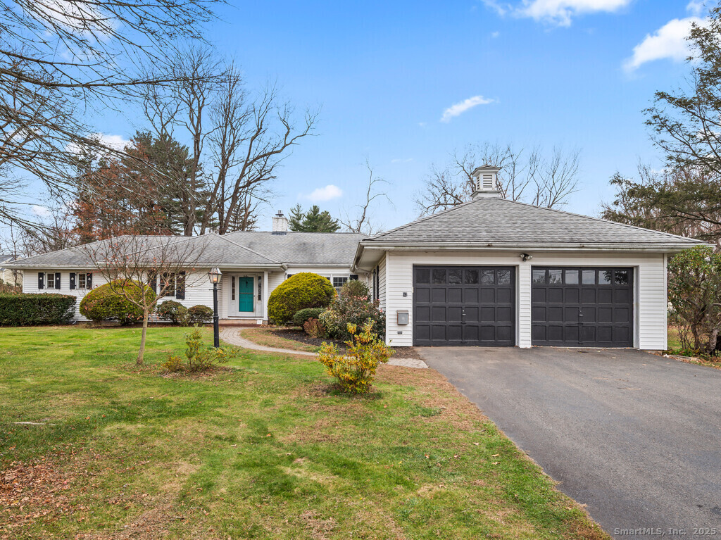a view of a house with backyard and a tree
