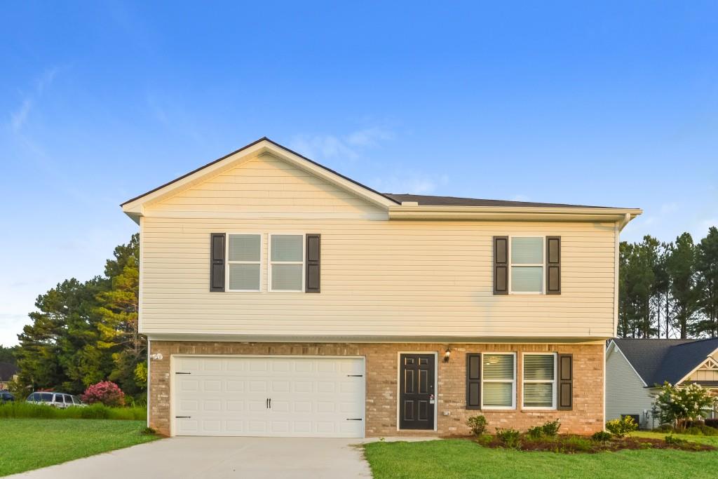 45 Chimney Ridge Lane Covington, GA 30014 - Photo 1 of 1 a front view of a house with garden
