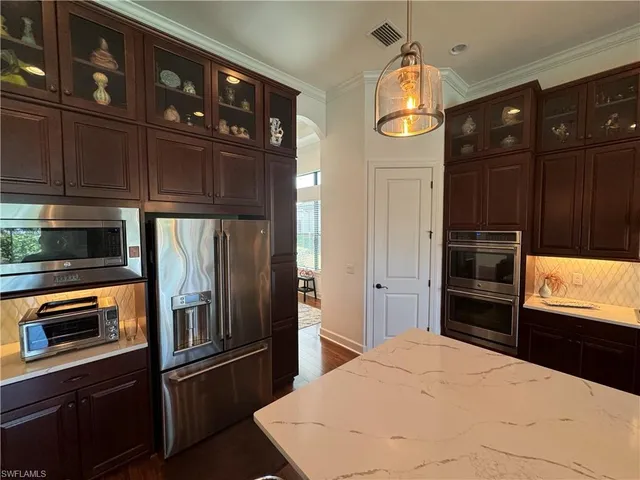 a kitchen with granite countertop stainless steel appliances and wooden cabinets