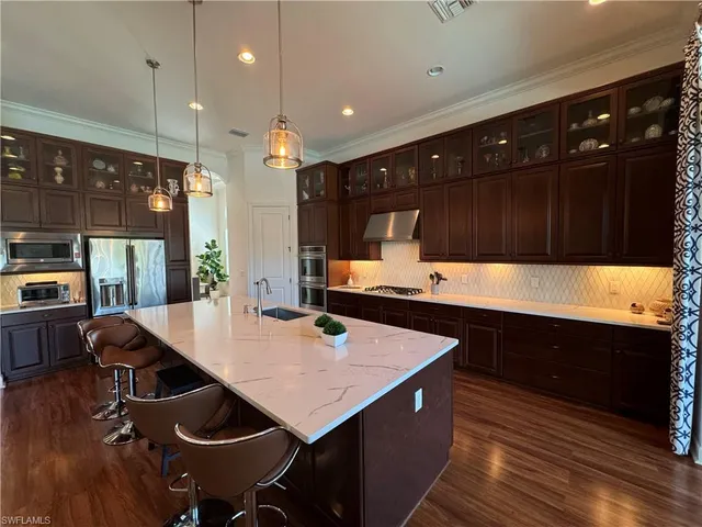 a kitchen with stainless steel appliances a sink and a refrigerator