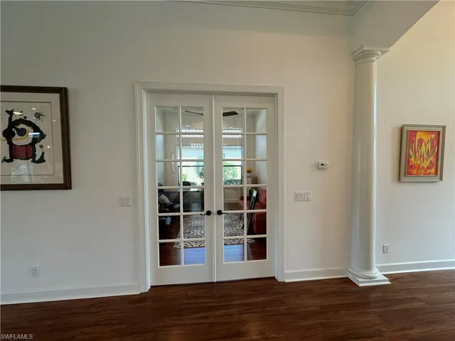 an empty room with wooden floor and closet