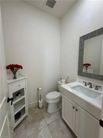 a bathroom with a sink toilet and vanity
