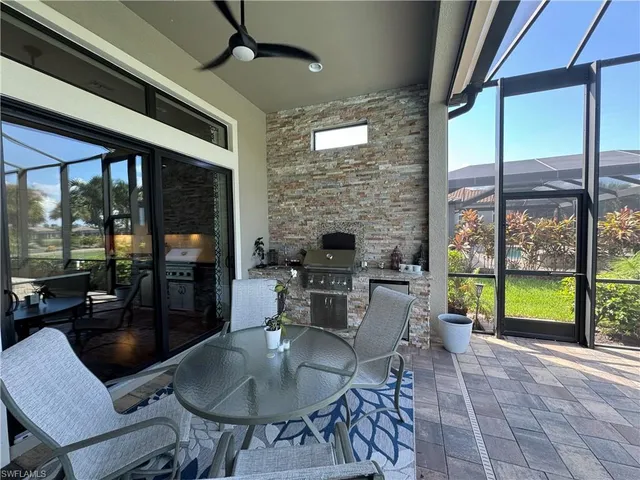 a dining room with furniture a chandelier and fireplace