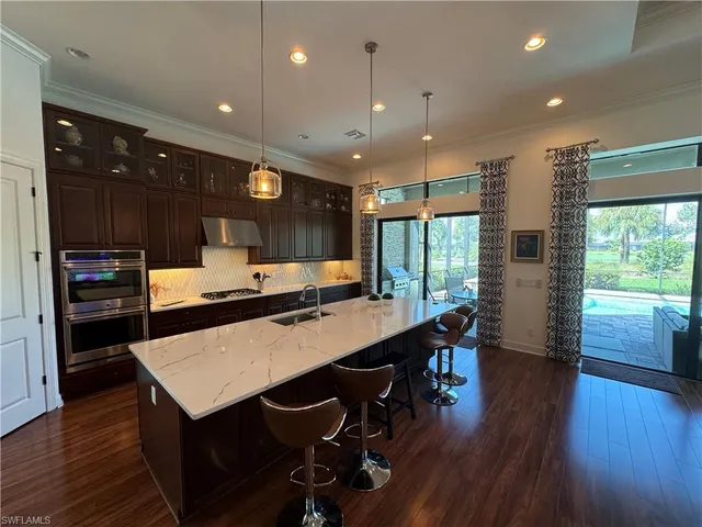 a large kitchen with a table and chairs
