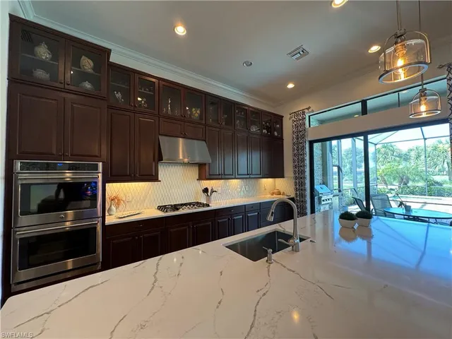 a large kitchen with stainless steel appliances wooden cabinets and a stove