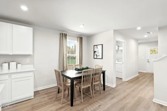 a living room with furniture white walls and a table