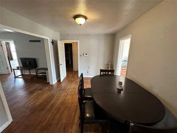 a kitchen with stainless steel appliances a refrigerator and wooden floor