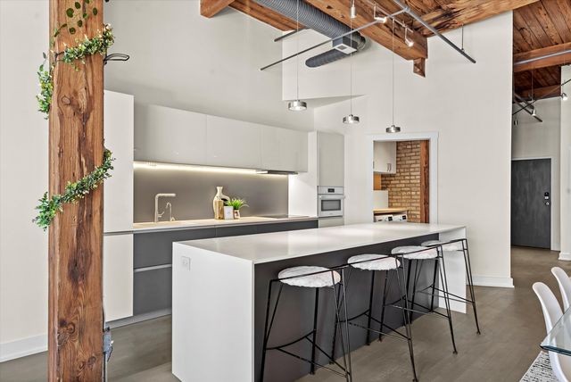 a kitchen that has a table and chairs in it