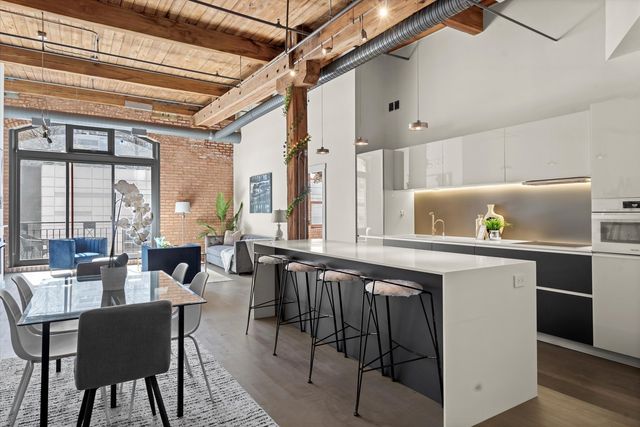 a kitchen with a table chairs stove and cabinets