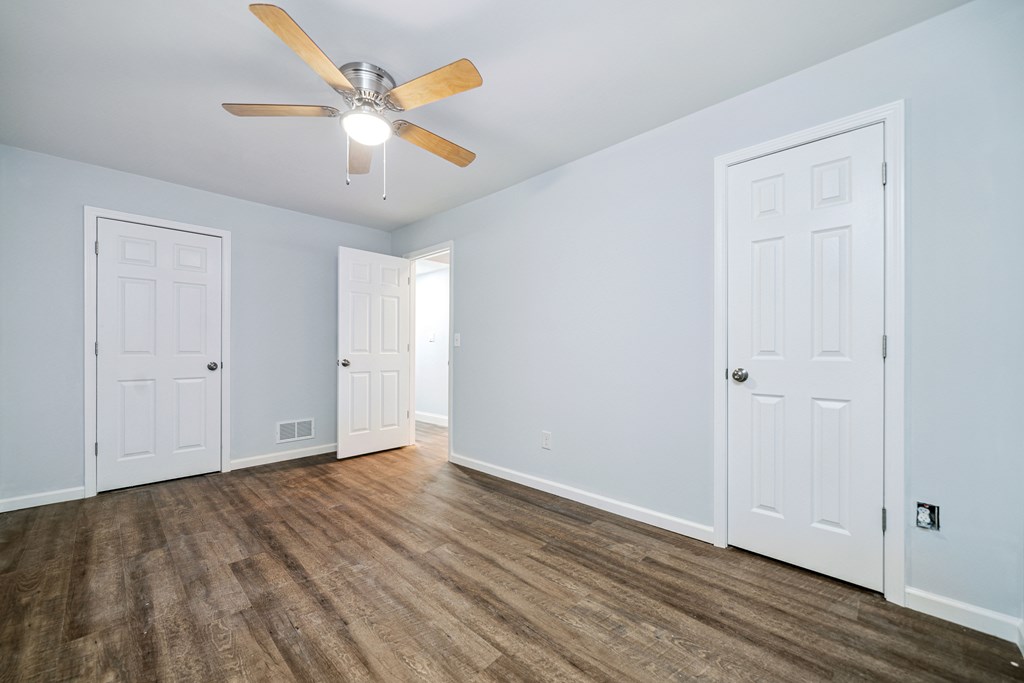 5055 Wright Bridge Road Cumming, GA 30028 - Photo 25 of 39 an empty room with wooden floor and ceiling fan
