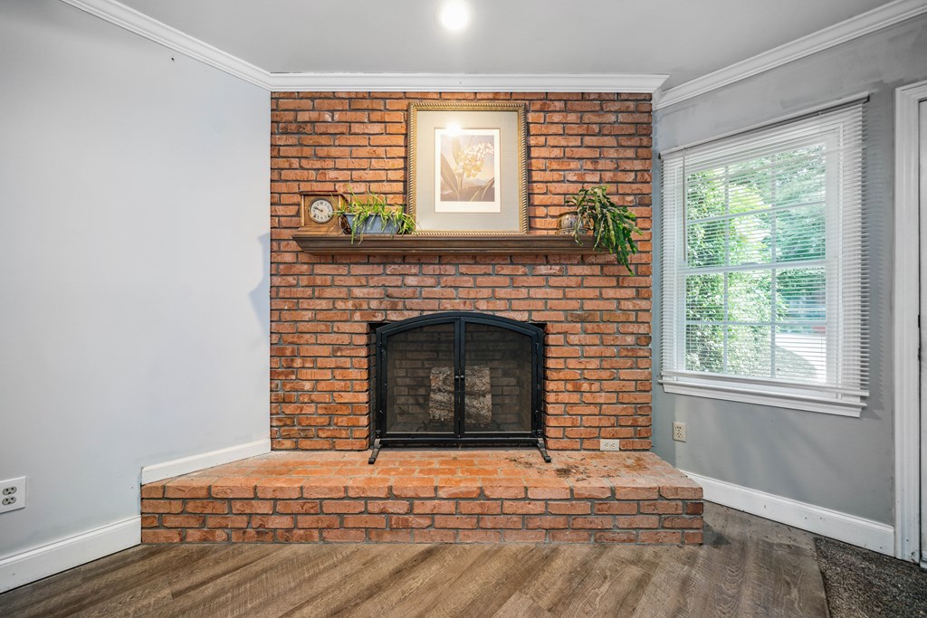 5055 Wright Bridge Road Cumming, GA 30028 - Photo 27 of 39 a living room with a fireplace and windows