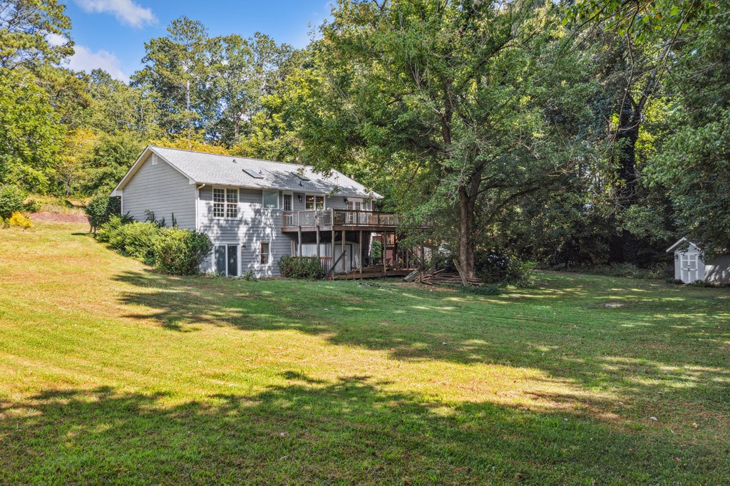 5055 Wright Bridge Road Cumming, GA 30028 - Photo 30 of 39 a view of a house with a big yard potted plants and large tree