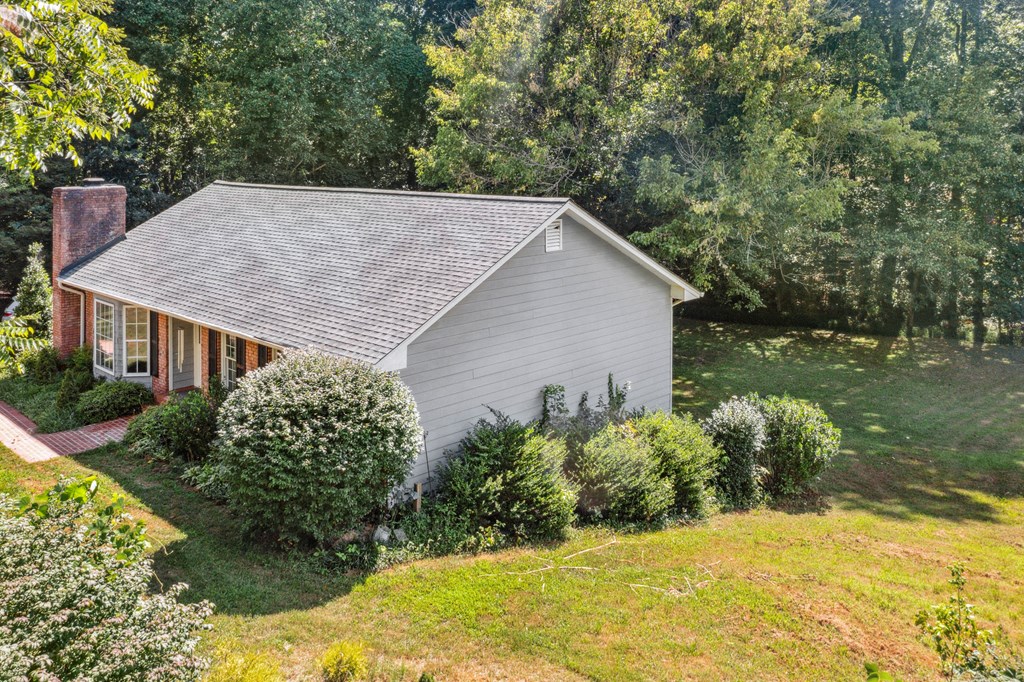 5055 Wright Bridge Road Cumming, GA 30028 - Photo 33 of 39 a view of a house with a yard and potted plants