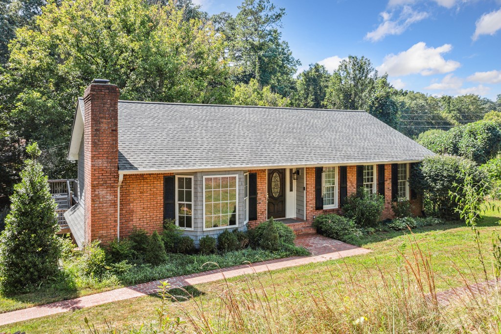 5055 Wright Bridge Road Cumming, GA 30028 - Photo 35 of 39 a front view of house with yard and trees in the background